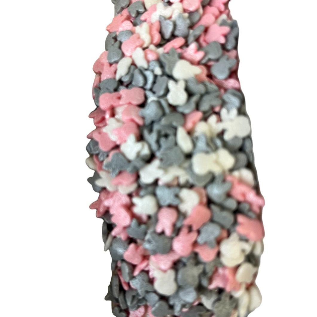 a close up of a candy bar with pink, grey, and white candies