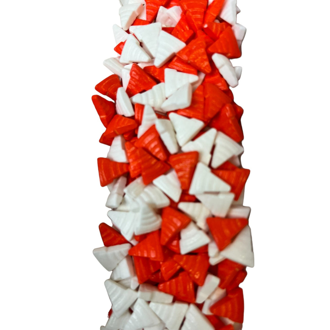 a tall red and white object with many pieces of red and white candy