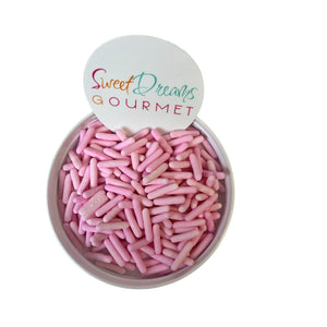 a bowl filled with pink sprinkles with a sign that says sweet dreams