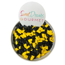 a bowl filled with black and yellow gummy bears