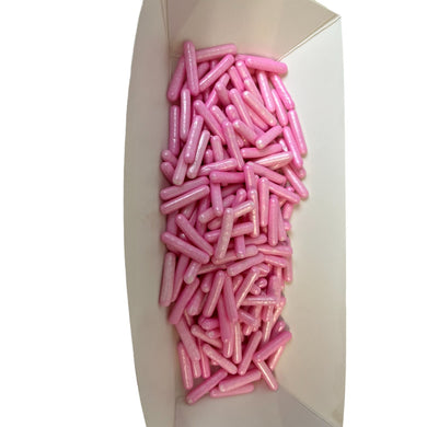 a white box filled with pink donuts on top of a table