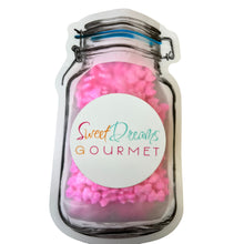 a jar filled with pink pom poms