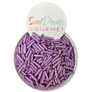 a white bowl filled with purple candy sticks