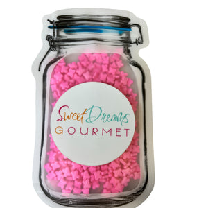 a jar filled with lots of pink sprinkles