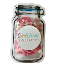 a jar filled with pink and white sprinkles