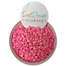 a bowl filled with pink hearts next to a sign that says sweet dreams gour