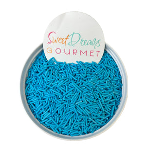 a bowl of blue sprinkles with a sign that says sweet dreams go