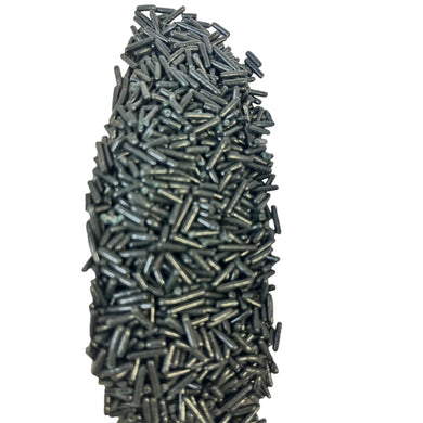 a pile of nails sitting on top of a white surface