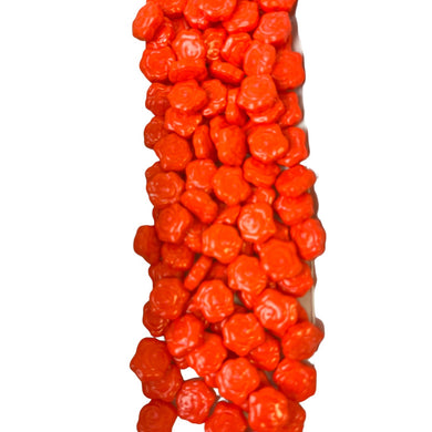 a large pile of orange candies on a white background