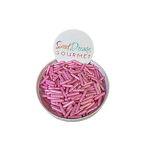 a bowl filled with pink sprinkles sitting on top of a white table