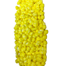 a bunch of yellow candy corn on a white background