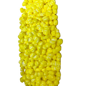 a bunch of yellow candy corn on a white background
