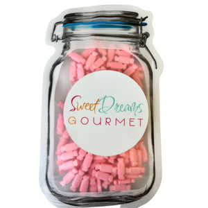 a jar filled with pink and white candy sticks