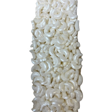 a white vase filled with lots of white spirals