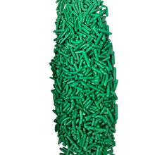 a large pile of green sprinkles on a white background