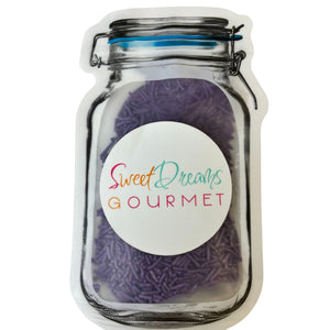 a jar filled with purple yarn sitting on top of a white table