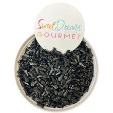 a bowl filled with black seed next to a sign that says sweet dreams gour