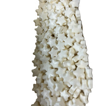 a white vase filled with lots of white cubes