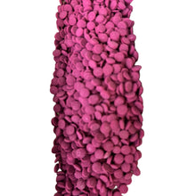 a purple vase with lots of pink balls on it