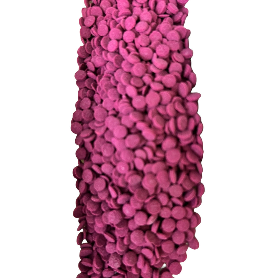 a purple vase with lots of pink balls on it