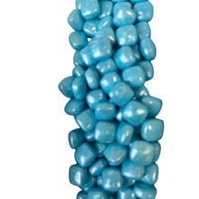 a bunch of blue candies sitting on top of each other