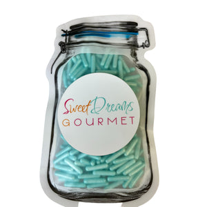 a jar filled with blue and green sprinkles