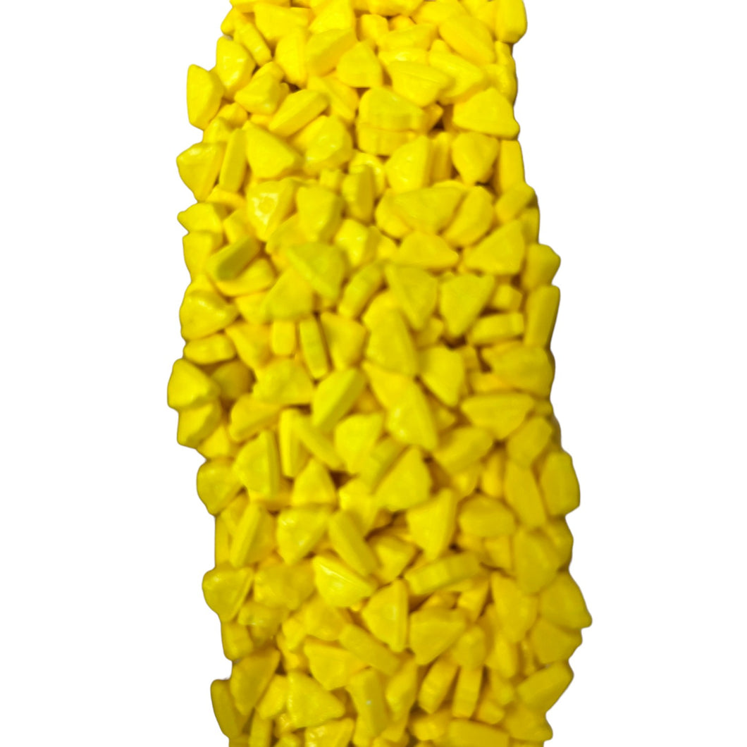 a bunch of yellow candy corn on a white background