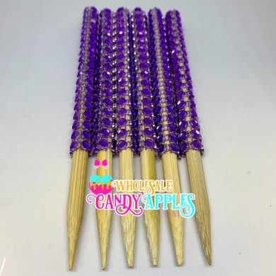 a bunch of purple beads on wooden sticks