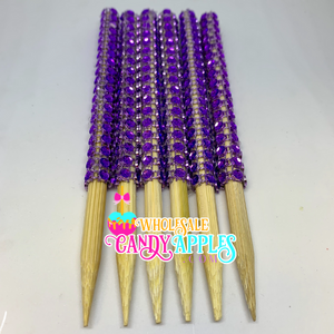 a bunch of purple beads on wooden sticks