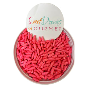 a bowl filled with pink candies next to a sign that says sweet dreams go