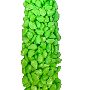 a large pile of green candies on a white background