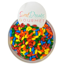 a bowl filled with colorful candy beans next to a sign that says sweet dreams go