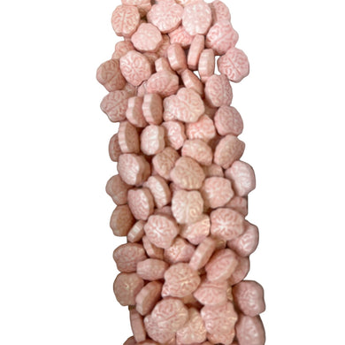 a pile of pink and white candies on a white background