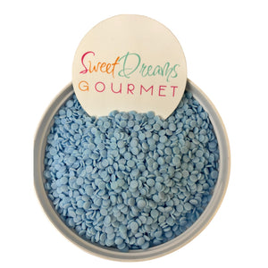 a bowl filled with blue beans next to a sign that says sweet dreams gour