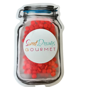 a jar filled with red gummy balls