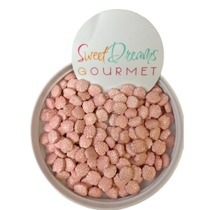 a bowl filled with pink cereal next to a sign that says sweet dreams gour