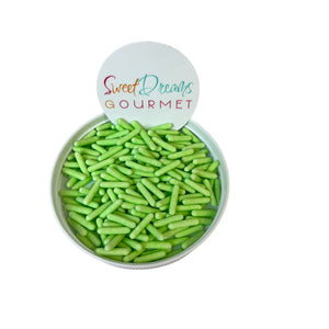 a bowl filled with green beans sitting on top of a white table