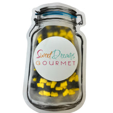 a jar filled with yellow and black gummy bears