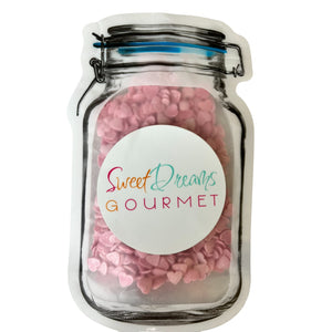 a jar filled with pink and white candies