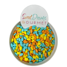 a bowl filled with candy corn and a sign that says sweet dreams gourmet