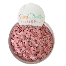 a bowl filled with pink candy hearts next to a sign that says sweet dreams go