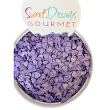 a white bowl filled with purple candy hearts