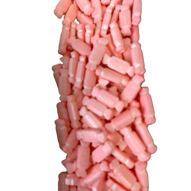 a pile of pink candy sticks sitting on top of each other