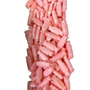 a pile of pink candy sticks sitting on top of each other