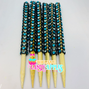 a group of blue and yellow beads on wooden sticks