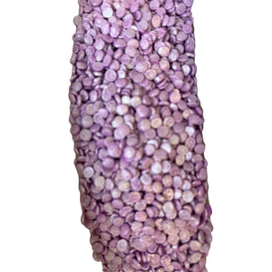 a vase that has a lot of purple beads on it