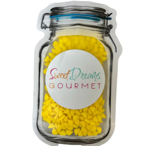 a jar filled with yellow candies and a label that says sweet dreams gour