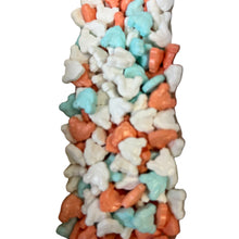 a large pile of candy corn sitting on top of a white table