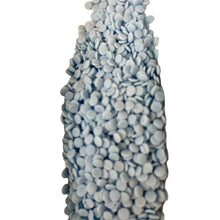 a blue vase filled with lots of white balls