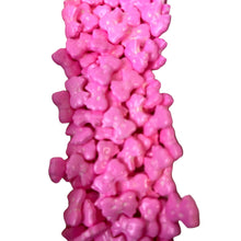 a pile of pink gummy bears on a white background